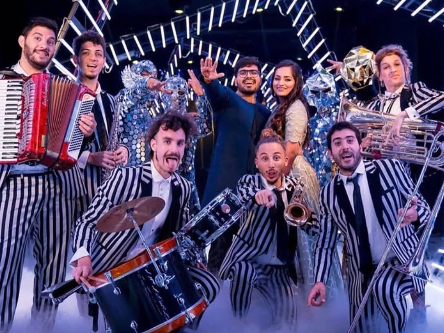 Desmadre XL in striped suits with the bride and groom at an Indian wedding